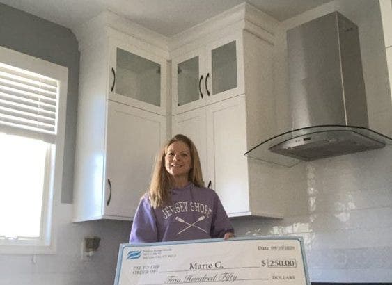 Photo Contest Winner With Check