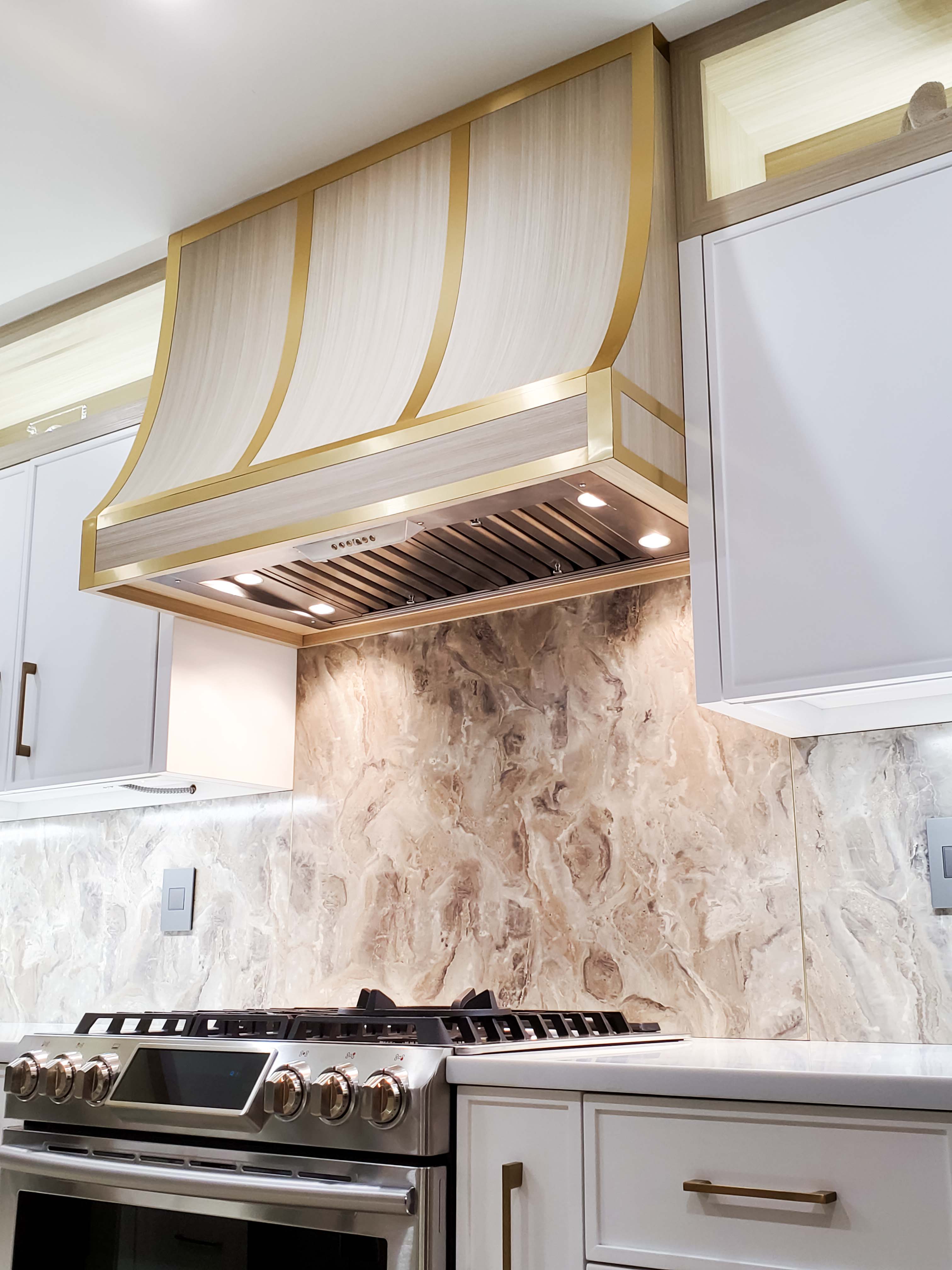 White range hood cover with golden trim