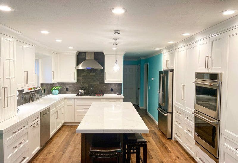 Wall Range Hood with White Shaker Cabinets