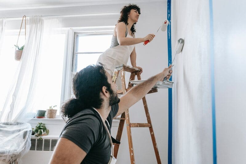 Couple Painting with Rollers