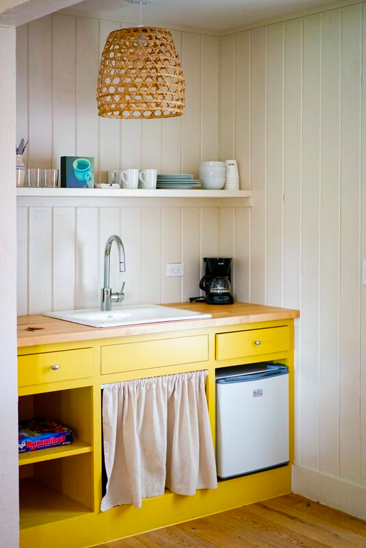 Pastel yellow cabinets with sink