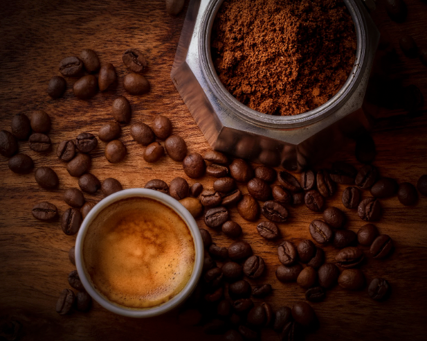 https://www.prolinerangehoods.com/blog/wp-content/uploads/2022/09/Coffee-Grounds-Coffee-and-Coffee-Beans-on-Brown-Wooden-Table.png