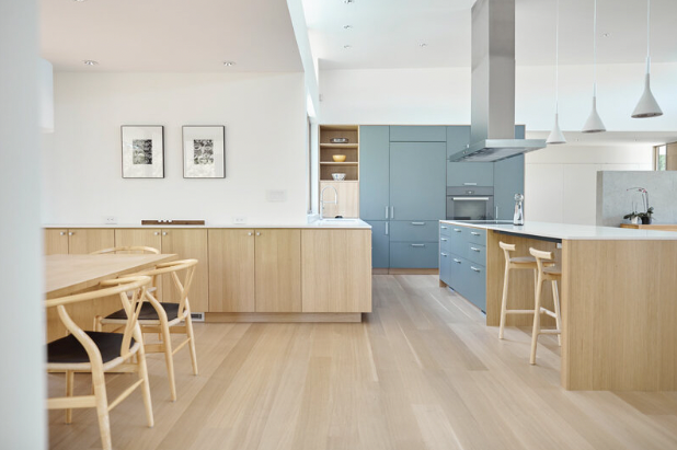 Sleek minimalist kitchen with large blue gray cabinets