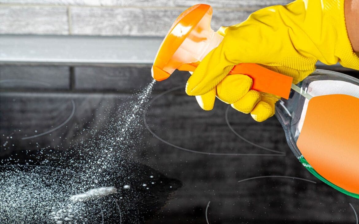 using kitchen cleaning spray with gloves on