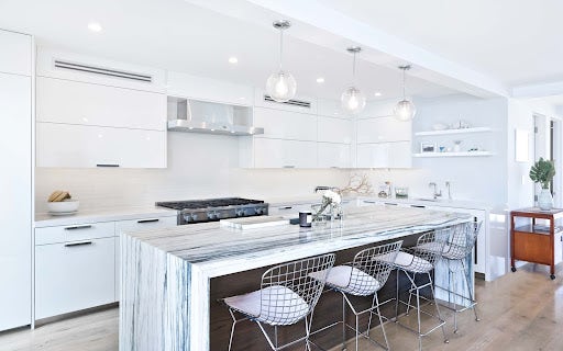 Modern White Kitchen with Marble Countertop and Stainless Steel Range Hood