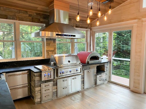 Laminate outdoor flooring with hood, grill, and pizza oven