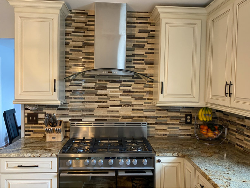 kitchen backsplash, quartz countertop, hood vent, cabinets