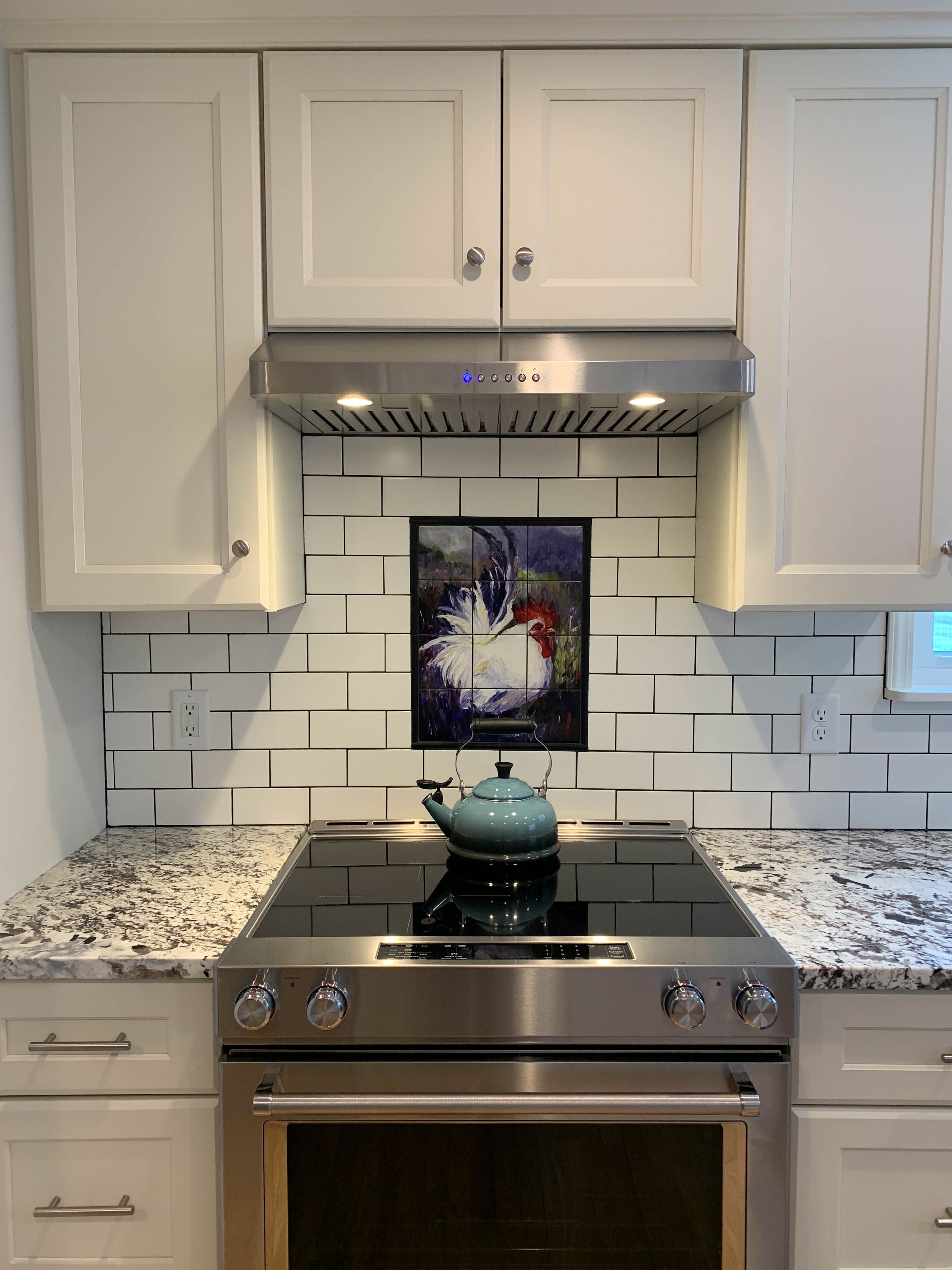 A Proline pljw 185 range hood in a kitchen with a tea pot on the stove