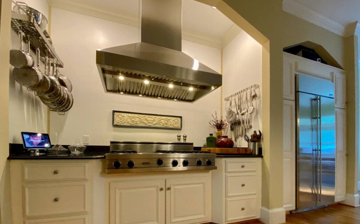 chef's cooking area with a gas range and a ducted range hood.