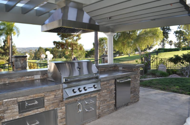 outdoor kitchen idea number 3
stainless steel appliances with a big range hood outdoor under a pergola