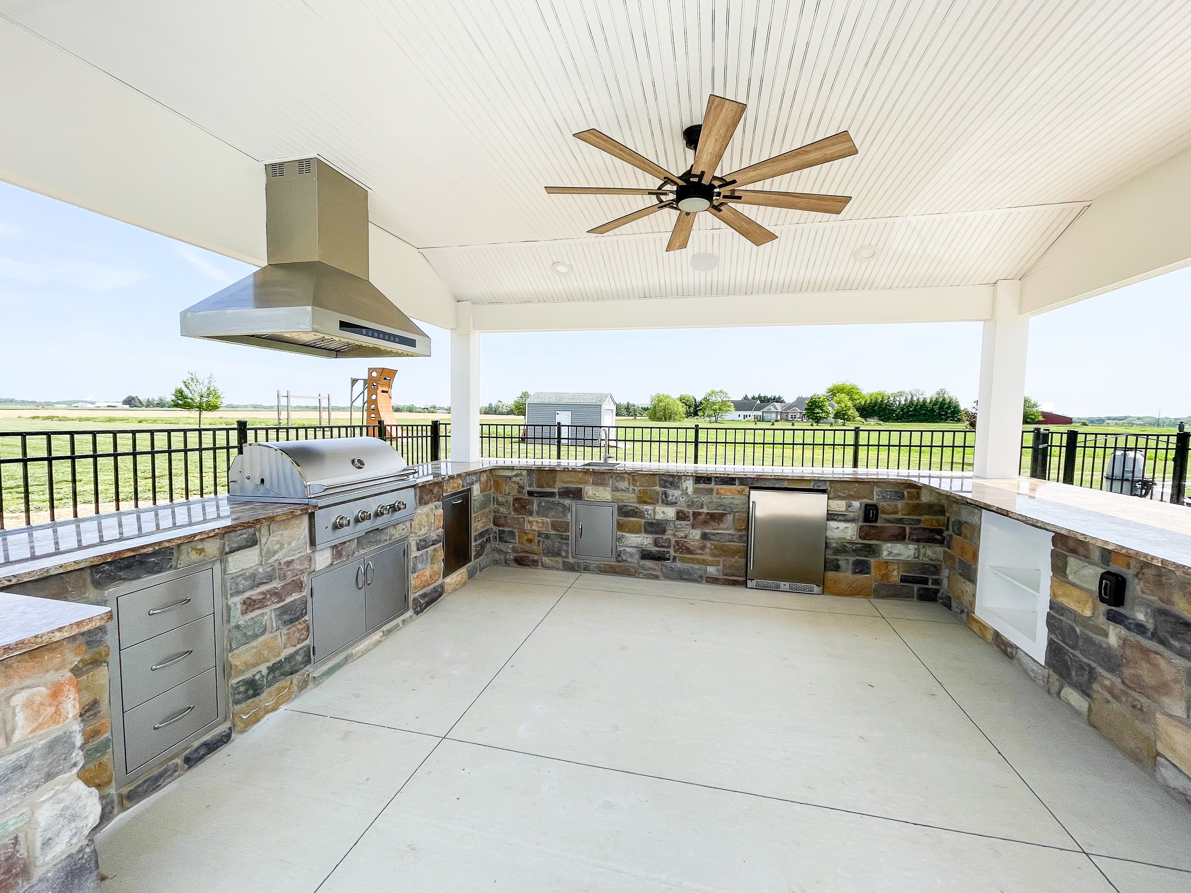 big outdoor kitchen with a proline outdoor range hood