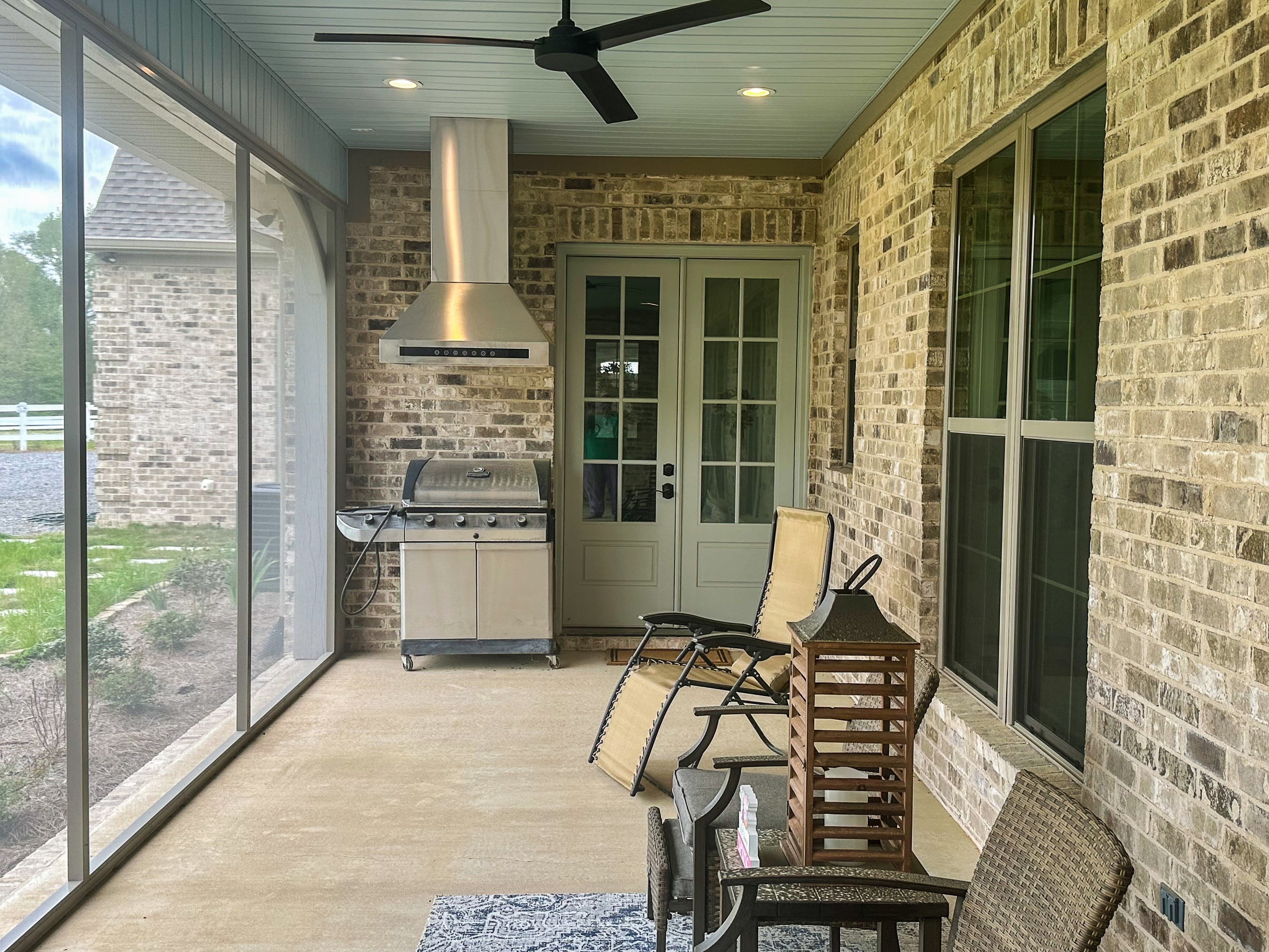 outdoor grill and hood in a three seasoned porch