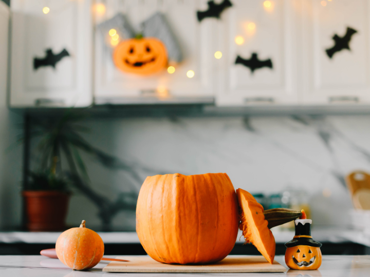 Halloween decoration in a kitchen. Jack o lantern decoration. Bats and pumpkins. 