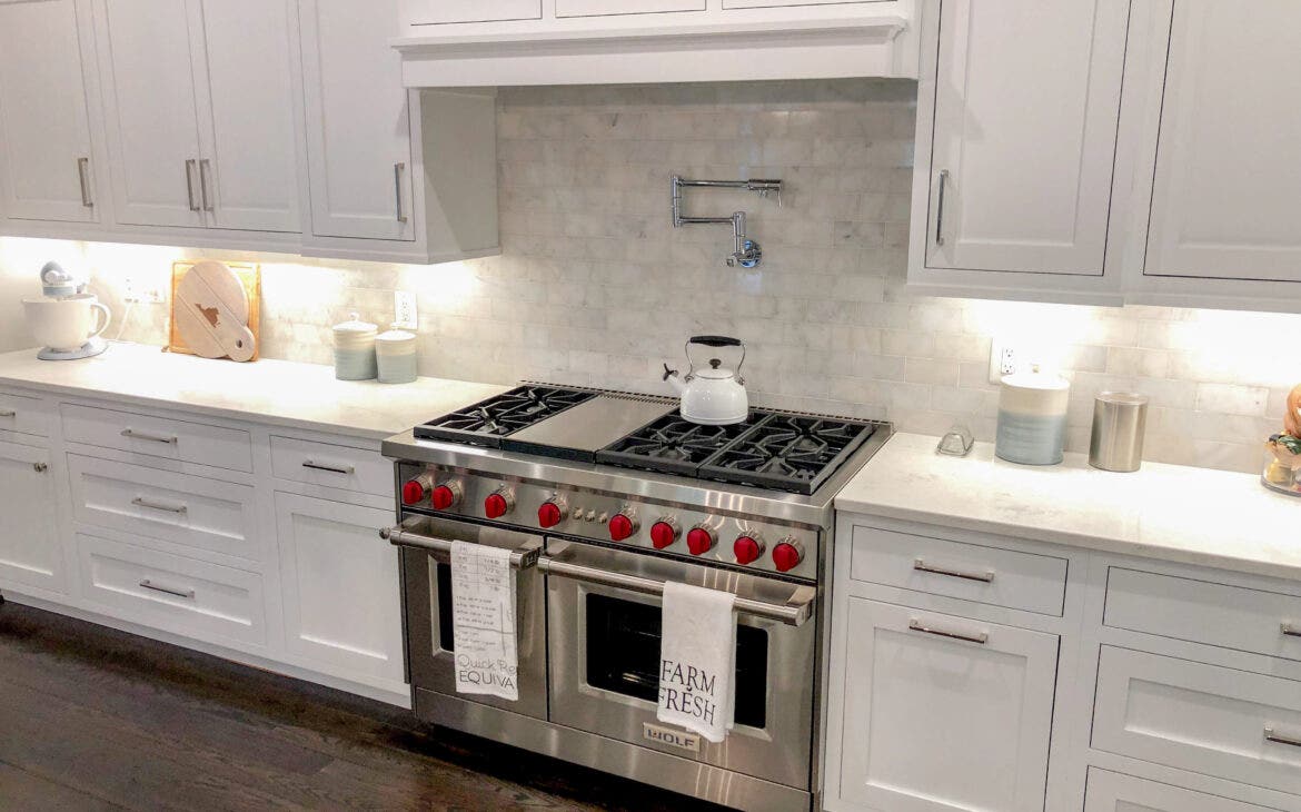 White Kitchen with Custom Hood and Stainless Steel Ranges