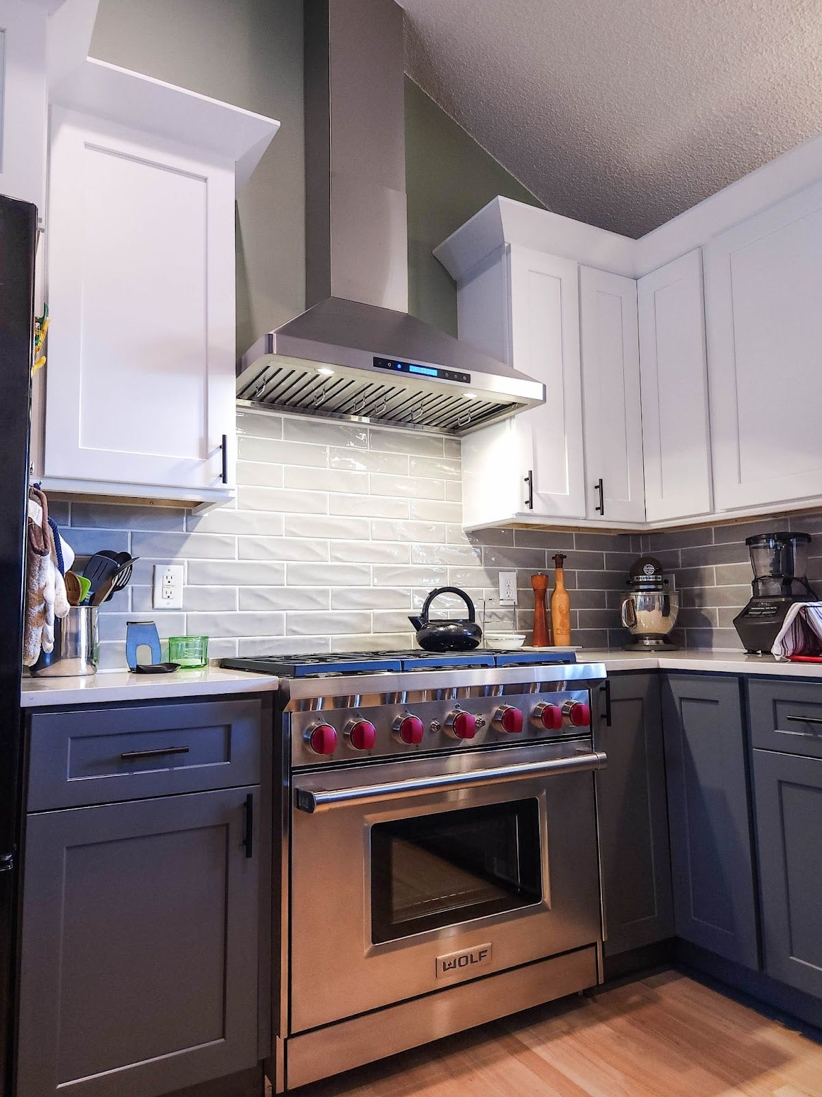 Proline range hood complements stainless steel appliances and white cabinets in a modern kitchen. - Proline Range Hoods - prolinerangehoods.com 