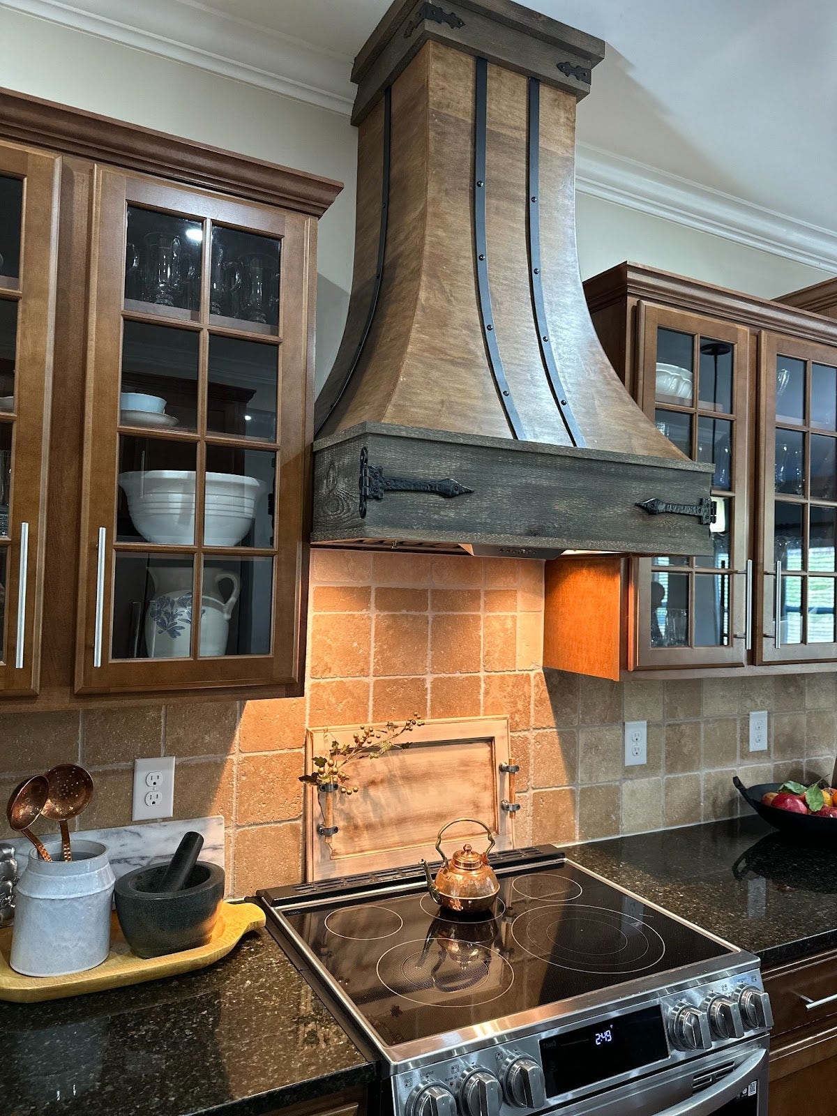Modern kitchen with stainless steel appliances and a Proline range hood, perfect for entertaining. - Proline Range Hoods - prolinerangehoods.com 