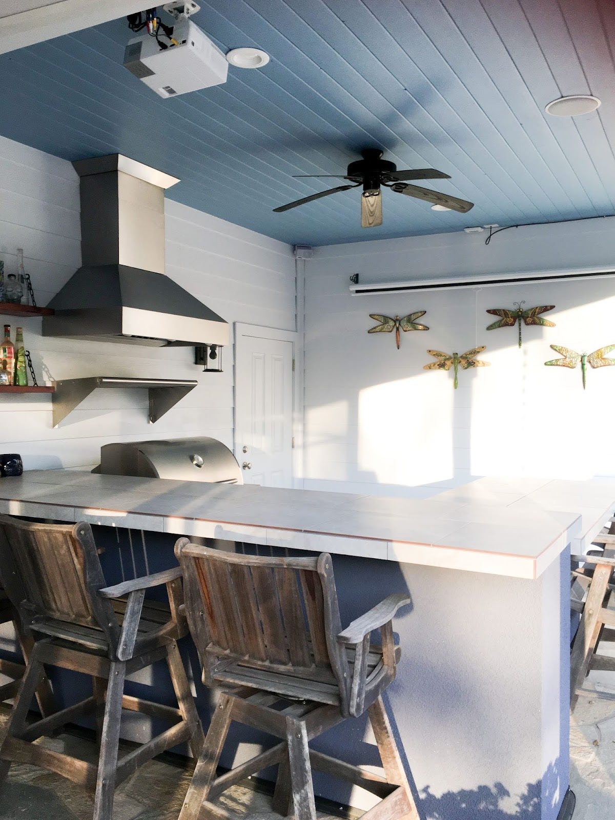 Beachy Bar & Grill: Proline hood adds a touch of function to this laid-back bar with a beachy vibe. Wood and blue ceiling create a nautical feel, perfect for grilling and chilling. - Proline Range Hoods - prolinerangehoods.com 