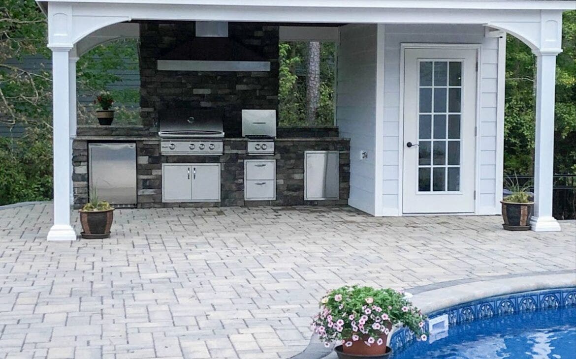 Stainless steel outdoor range hood mounted in a pool house, keeping smoke and grease away from the pool area.  - Proline Range Hoods - prolinerangehoods.com 