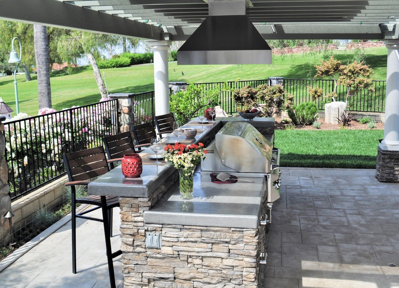Suburban Backyard Oasis: Proline PLJI 103 hood keeps the air clear in this outdoor kitchen. Stone finishes and a lawn view create a relaxing space for gatherings. - Proline Range Hoods - prolinerangehoods.com 