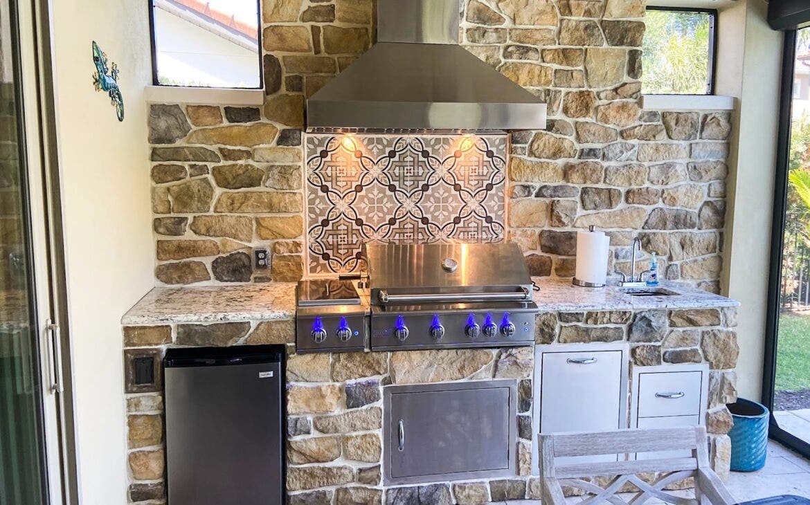 awesome outdoor kitchen with a vent hood and lights and counter and sink and appliances - Proline Range Hoods - prolinerangehoods.com 