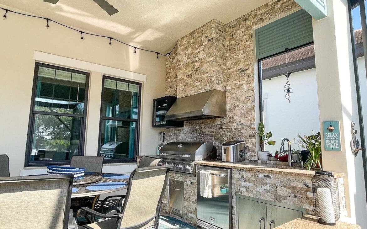 Outdoor Kitchen Oasis: Unwind in your private escape! Stone walls & stainless steel grill create a stylish space. Grill feasts,  - Proline Range Hoods - prolinerangehoods.com grab drinks from the ice maker/mini-fridge, then dine alfresco under string lights. Relax & soak up the sun!