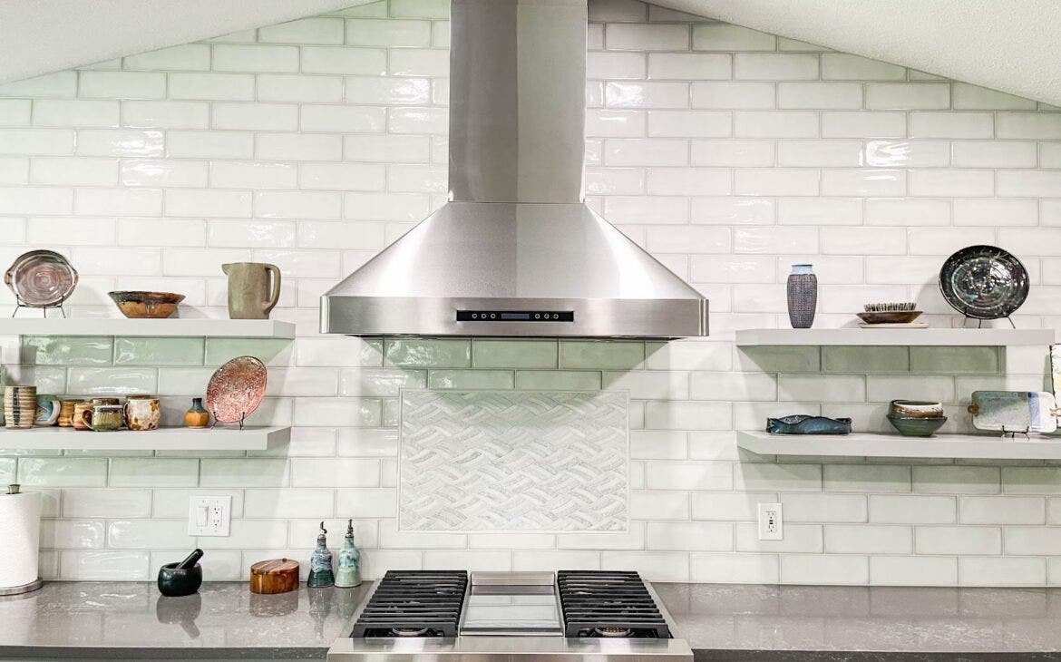 Modern kitchen stovetop with hood and shelves for storage and a beautiful Proline range hood. - Proline Range Hoods - prolinerangehoods.com 