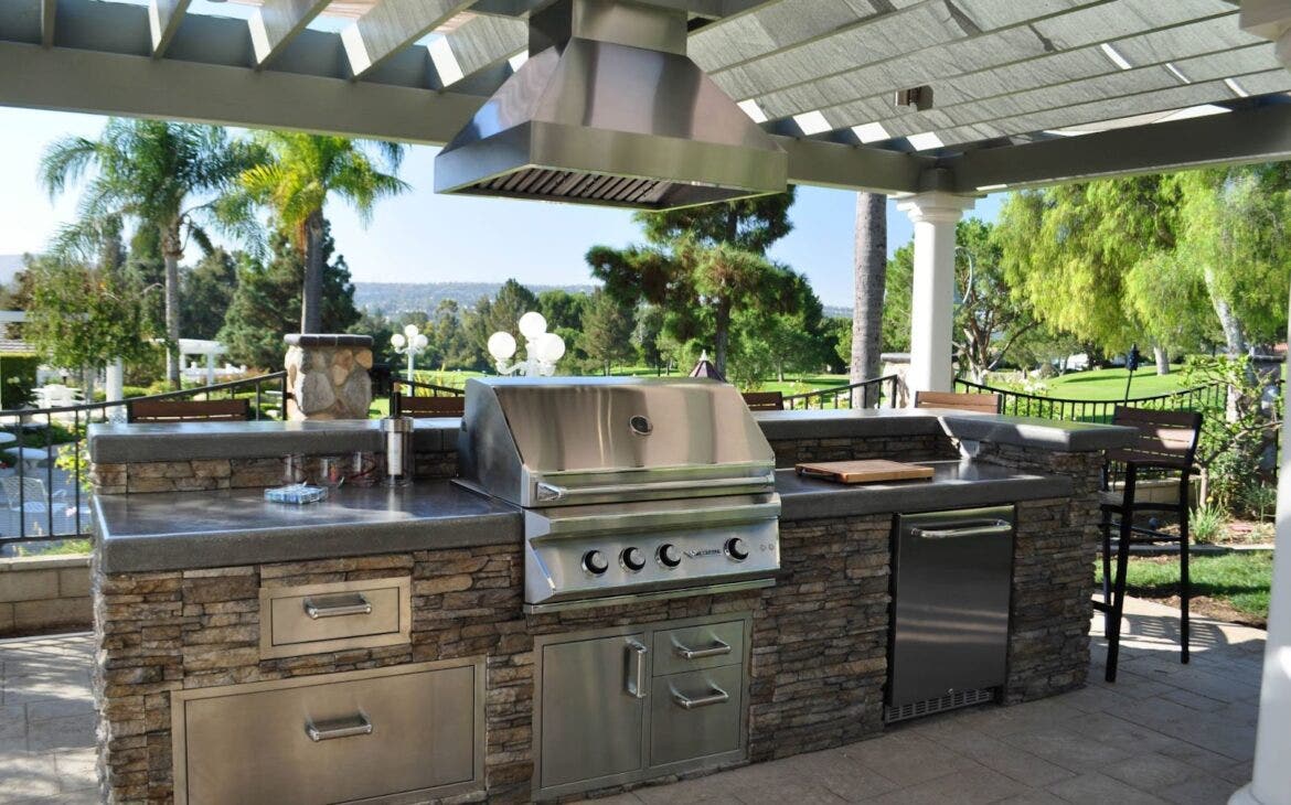 State-of-the-art Proline outdoor range hood over an expansive stainless steel grill, designed for the ultimate BBQ enthusiast - available at prolinerangehoods.com.