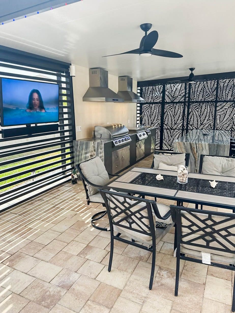 Contemporary outdoor living space with a dual Proline range hood setup for the grill area, creating a stylish and functional gathering spot - prolinerangehoods.com.